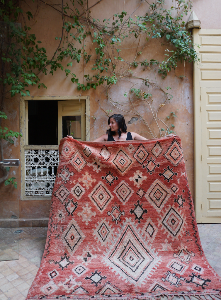 Vintage, red, moroccan rug shown with traditional diamond motifs