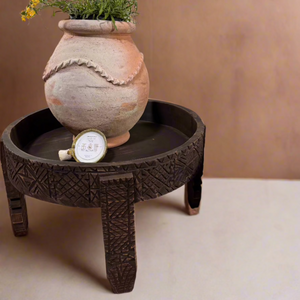 Small Moroccan terracotta planter with greenery on a wooden table